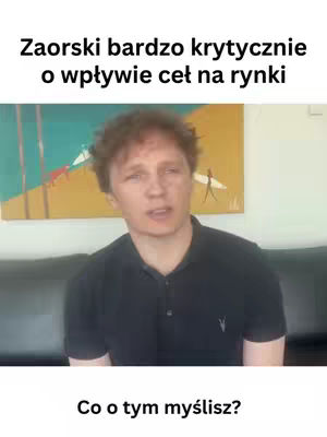 A man with short, wavy brown hair is centered in the frame, looking directly at the viewer and speaking. Above him, a painting with yellow and green hues is partially visible on the wall. Below the man, the text 'Co o tym myślisz?' in white font. The overall tone suggests a discussion or commentary.