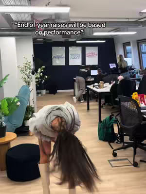 The cover image shows a woman bending over with her head down, appearing as though she is picking items up, or adjusting something. The setting is an office with multiple people.