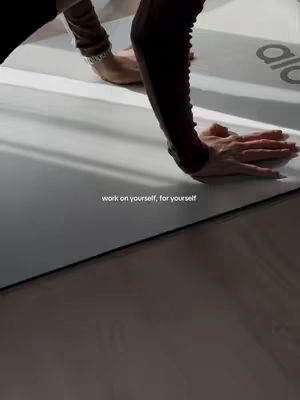 The cover image shows a person in a yoga pose, bending over a yoga mat. The mat is light-colored, and the arms and some of the upper body of the person are visible. The text overlay "work on yourself, for yourself" is placed at the bottom.