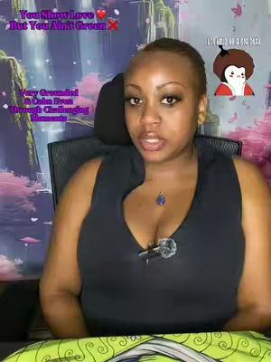 A woman with short hair is centered in the frame, looking directly at the camera. She wears a black top and a pendant necklace. Text overlays include spiritual themes and a cartoon character in the top corner on the right.