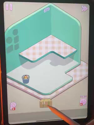 The cover image shows a digital recreation of a room as if viewed from an isometric perspective. The room has sections that look like walls and elevated floors in a light mint shade. There's a small table against one wall with a checkered tablecloth. There appears to be a small pot with a figure in it on the lower floor. A colored stylus is touching a button at the bottom right of the screen in the form of a gift box. There are some user interface items like timers in the corners. The overall look is clean and cartoonish.