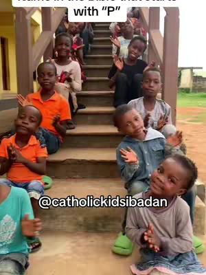 A group of children in various outfits are seated on a staircase. Some are clapping, others are waving towards the camera. Text overlays at the top and bottom that read 'Name in the Bible that starts with “P” How many names do you know✝️'.