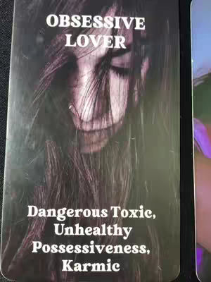 A dark, vertical tarot card design featuring a blurred, grayscale image of a person with long hair obscuring their face. The text overlay, in clear white font, reads 'OBSESSIVE LOVER' at the top and 'Dangerous Toxic, Unhealthy Possessiveness, Karmic' at the bottom.