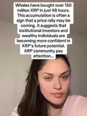 A woman with light skin and dark hair looks directly at the camera, the background is out of of focus. A text overlay in a white rounded square shape contains information about whales buying XRP in 48 hours and its potential impact. The woman is wearing a pink shirt.