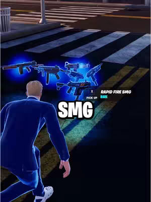 The image shows a scene from the game Fortnite. A male character in a blue blazer is kneeling and looking down on a collection of weapons with a street background and crosswalk.