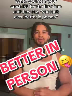 The cover photo features a young man in a white tank top, looking upwards with a somewhat surprised expression. Bold text overlays reading "BETTER IN PERSON" in a white font with a red shadow effect. A yellow emoji with hearts for eyes and a tongue sticking out is added to the right, enhancing the image's humorous theme. The background appears to be an interior space, possibly a living room, with a focus on personal interaction.