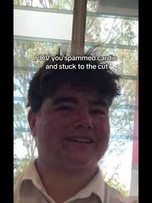 A close-up shot features a young man with dark, tousled hair. The background is blurred but shows a window with a view of the outside. The man is looking towards the camera and smiling. Overlaid on the image is white text in a simple font.
