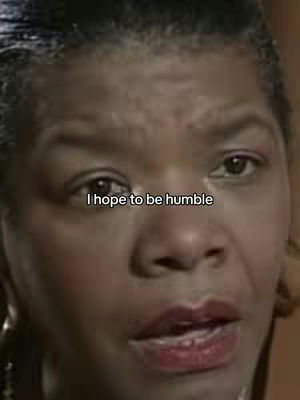 The image is a close-up shot of a woman's face. She has dark hair and brown eyes. The lighting seems to be soft and natural. Text overlayed in a white font at the bottom reads "I hope to be humble".