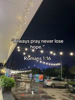 An outdoor nighttime scene with a street and a business facade illuminated by string lights. Text overlays on the top right and bottom center of the image.