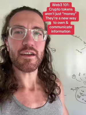 A selfie-style shot featuring a man with glasses and a beard, centered in the frame of a white board. There is text overlay on the top right of the image. The man has mid-length brown hair and is wearing a gray tank top, and looking directly at the camera. The background includes white-board with diagrams and text.