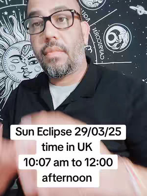 A man wearing glasses is centered. The background shows a celestial chart-themed tapestry, with a text overlay informing what time the Sun Eclipse will be on March 29, 2025, in the UK.