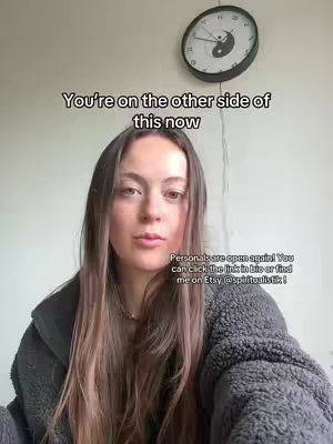 A woman with long brown hair is centered with a gray fuzzy jacket, the top with white text that says 'You're on the other side of this now'. A clock with a yin-yang symbol is located at the top, and a second text overlay is placed at the bottom.