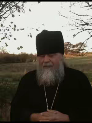 The cover image shows a man with a long white beard and a black hat standing outdoors with a blurry neutral background. He's wearing a black robe and a silver necklace.