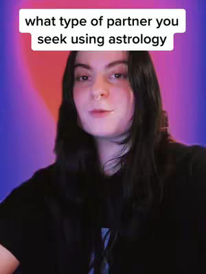 The cover image showcases a woman with long, dark hair, a nose ring, and a black top. She is looking at the camera, over a blended gradient background of red and blue. A text rectangle positioned above her head states that the video will explore which type of partner you seek using astrology.