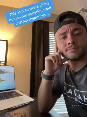 A man wearing a black cap and a dark t-shirt is sitting at a desk with a laptop on it. On the cover image, a blue text overlay is superimposed. The man is looking at the camera with a serious expression, and in the background, there is a curtain and a window.