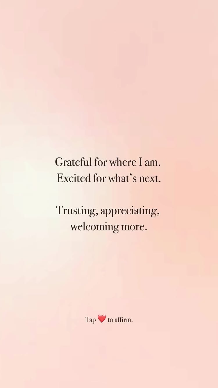 A vertical image with a soft, gradient background transitioning from a light peach at the top to a slightly darker, warmer peach at the bottom. Centered on the image is text in a clean, sans-serif font, arranged in three distinct sections. Above, a sentence begins, 'Grateful for where I am.' Immediately below, another sentence follows, 'Excited for what's next.' Beneath that, a third section starts with the word, 'Trusting,' then continues with, 'appreciating, welcoming more.' At the very bottom, there's an instruction, 'Tap ❤️ to affirm.' with a heart emoji.
