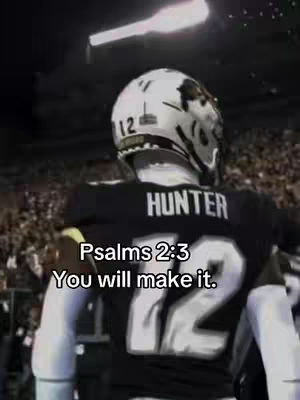 The image shows the back of an American football player wearing a black jersey with the name "HUNTER" and the number "72" on it. The background is blurry but seems to be a stadium at night with lights and possibly a crowd. Text overlayed says, "Psalms 2:3 You will make it."