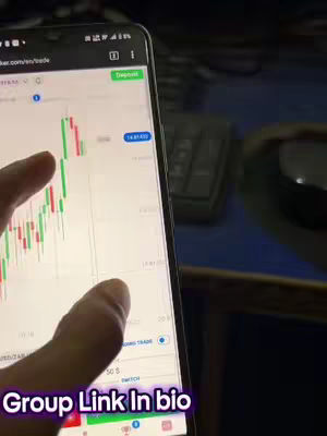 A close-up shot of a smartphone displaying a trading interface with a stock chart, a finger is pointing at the screen, with a background calculator and other objects in the blurry background. The text overlay says 'Group Link In bio'.