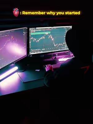 A dark cover image showing a person at a desk with two computer monitors displaying financial charts. The person is partially obscured by a hoodie, with only their hands visible at the keyboard. A heart icon with the phrase Remember why you started is also overlayed on top.