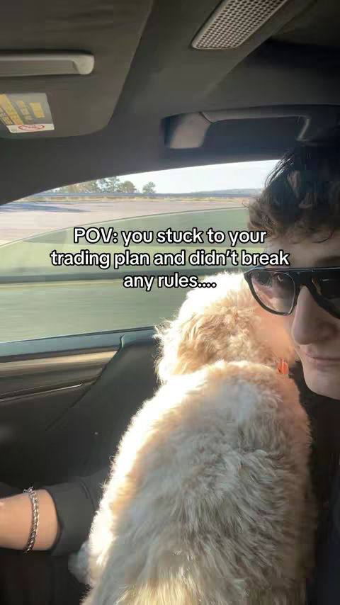 A person in a car with a dog in the front seat with overlay text.