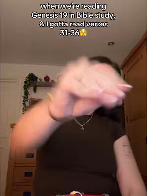 The image shows a person, partially visible with their arm in the foreground, reaching towards the camera. In the background, there's a shelf with decorations and text overlaid at the top.