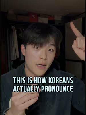 A young Asian man with short black hair, wearing a dark collared shirt, is centered in the cover image. He looks directly at the viewer with an open-mouthed expression as if speaking. His right index finger is up, pointing towards the upper right corner, and the text overlayed on the bottom of the image reads, “THIS IS HOW KOREANS ACTUALLY PRONOUNCE”