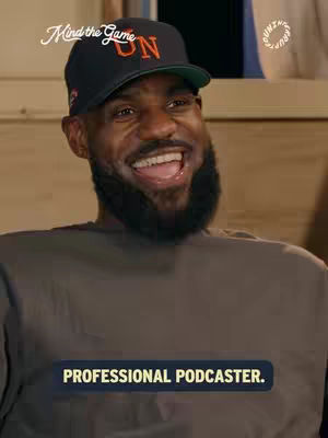 The cover image features a close-up of LeBron James smiling. He's wearing a black baseball cap with orange text and a black beard. The background is blurry but appears to be indoors. A text overlay at the bottom reads 'PROFESSIONAL PODCASTER.'