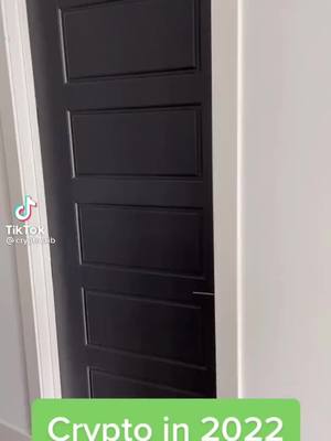 A close-up shot of a black door, partially open, with a white wall in the background on the right side. Text overlayed at the bottom.