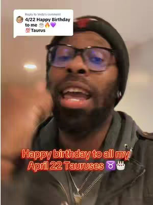 A man with glasses and a black beanie speaks directly to the camera. Text overlays read, "Happy birthday to all my April 22 Tauruses," with Taurus symbols.