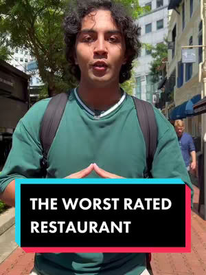 A young man with curly hair stands in front of a building, hands clasped near his chest. The image features overlay text announcing the worst-rated restaurant.