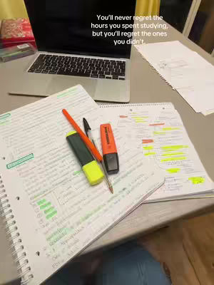 A student's desk with a laptop, notepads, pens, and highlighters are laid out. A hook text is overlaid on the image.