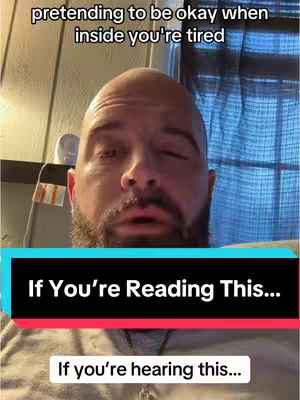 A bald man with a beard looks at the camera, the top of the image has text saying 'pretending to be okay when inside you're tired.' A black banner says 'If You're Reading This...' and a further banner says 'If you're hearing this...'The background has a wooden wall and a blue curtain.