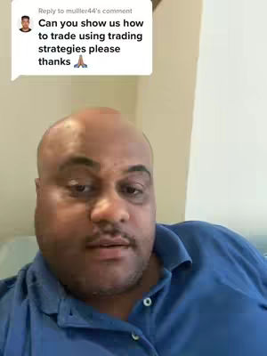 A man with a shaved head and a goatee is the central focus. The background is neutral, and he wears a blue polo shirt. A text overlay in the upper left corner references a comment about trading strategies.