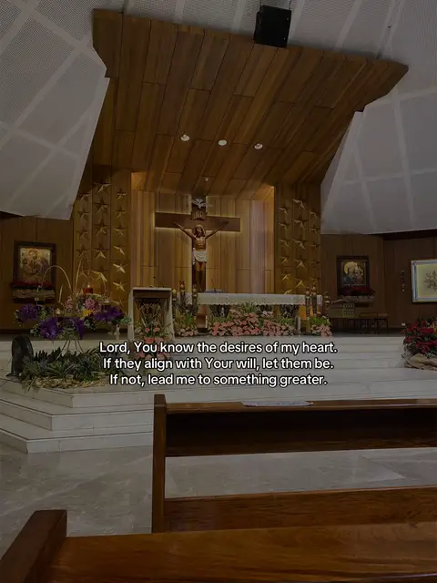 The image shows the interior of a church with ornate wooden paneling on the ceiling and walls, and a crucifix is a focal point.