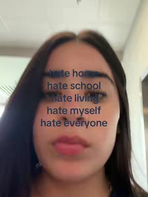 A close-up shot featuring a young woman with dark hair and visible eye lashes. Text overlays the woman's face.