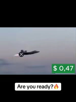The cover image shows a dark gray jet aircraft flying against a pale blue sky. A logo, seemingly an "X" inside a circle, is overlaid on the aircraft. A green rectangle with white text displays "$ 0,47". At the bottom, a white bar displays the phrase, "Are you ready?" with a fire emoji.