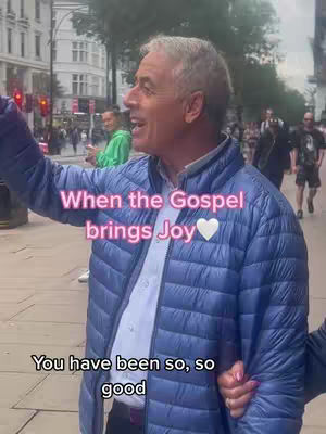 An older man with gray hair is smiling broadly outdoors, pointing to his left. The cover image is slightly overexposed. Text overlayed in pink with a heart symbol reads, "When the Gospel brings Joy." Below this, the text continues as "You have been so, so good." Background elements include a busy street scene with other people walking by.