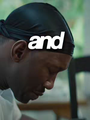 The cover image shows a close-up of a Black man's face, seen from the side profile, wearing a black durag. The text overlayed is 'and' in a bold white font.