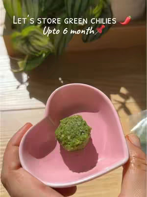 The cover image shows a close-up view of a hand holding a pink heart-shaped dish. Inside the dish is a green paste, likely a food preparation. The background suggests a kitchen setting with blurred elements. The upper portion includes text related to the content.
