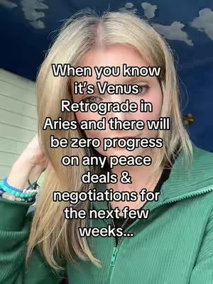 A woman with long blonde hair gazes at the camera in a selfie-style shot. She wears a green zip up and has a beaded bracelet on her left wrist. Text overlays the image.