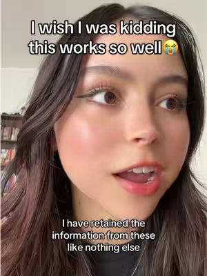 A young woman with dark hair and fair skin is the central focus of the image. She is looking towards the side with a slightly open mouth as if she's speaking. The background is slightly blurred suggesting an indoor setting.