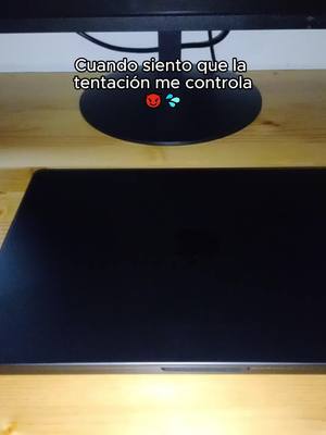 The image shows a laptop on a wooden surface with a monitor behind it. Text overlays the monitor.