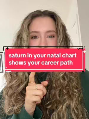 A woman with long, wavy blonde hair is in a well-lit, indoor setting. Overlay text is present on the image in a red box. The woman is wearing a dark green top and has rings on her fingers. She is pointing towards the camera with the index finger of her right hand.