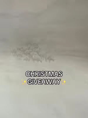 An image with a foggy background, featuring what seems to be a herd of animals. There is overlay text at the middle that says "CHRISTMAS GIVEAWAY" in a bold white font embellished by small yellow star shapes.
