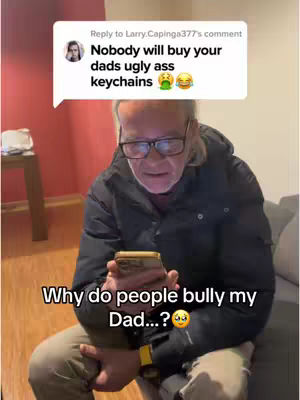An older man wearing glasses sits holding a phone and looking stressed. A speech bubble above shows a negative comment. Text below the man asks why people bully his dad.