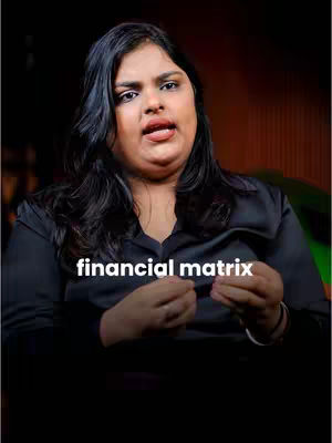 A woman with dark hair and wearing a black shirt is the central focus. The text overlayed on the image reads 'financial matrix.' The background is dark, with a blurred green and gold tint on the right.