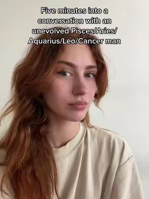 A young woman with auburn hair is centered in the frame. She wears a beige t-shirt and looks slightly to the side, towards the viewer. Text is overlaid on the image.