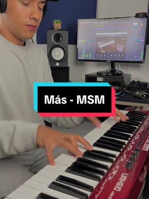 A man is shown seated and playing a red keyboard, positioned in a studio setting with recording equipment and a computer screen displaying music-related software. A text overlay at the bottom of the screen provides the video title.