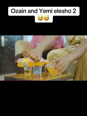 The image features a scene of what seems to be a fun activity. The subjects are busy pouring a yellow liquid from what seems to be a orange juice container into clear cups. The scene is well-lit and has a warm, inviting atmosphere. The subjectsβ casual attire and the setting indicate a relaxed social scenario, possibly a friendly gathering or a casual meal.