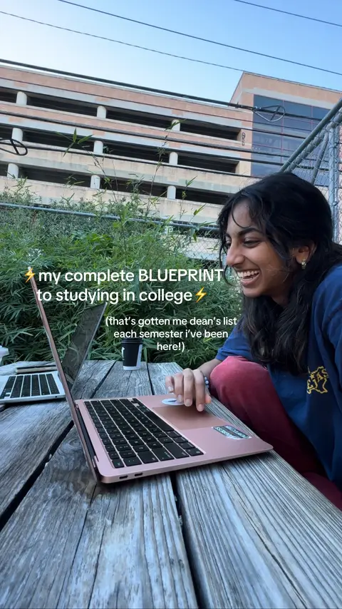 A young woman sits at a wooden table outdoors with a laptop in front of her. Text overlays the image. The background shows foliage and parts of a building.